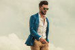 © Viorel Sima - smart casual man with sunglasses on grey clouds background