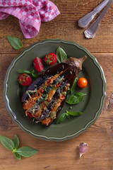 Canvas Print - Baked eggplant stuffed with meat stew, tomatoes, paprika and cheese. Fan of eggplant. View from above, top studio shot