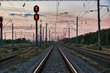 © soleg - railroad traffic lights and infrastructure during beautiful sunset, colorful sky, transportation and industrial concept