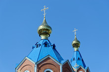 Blue Roofs Of Russian Orthodox Church Against Clear Blue Sky. Cathedral Of Our Lady Of Kazan In Komsomolsk-on-Amur In Russia