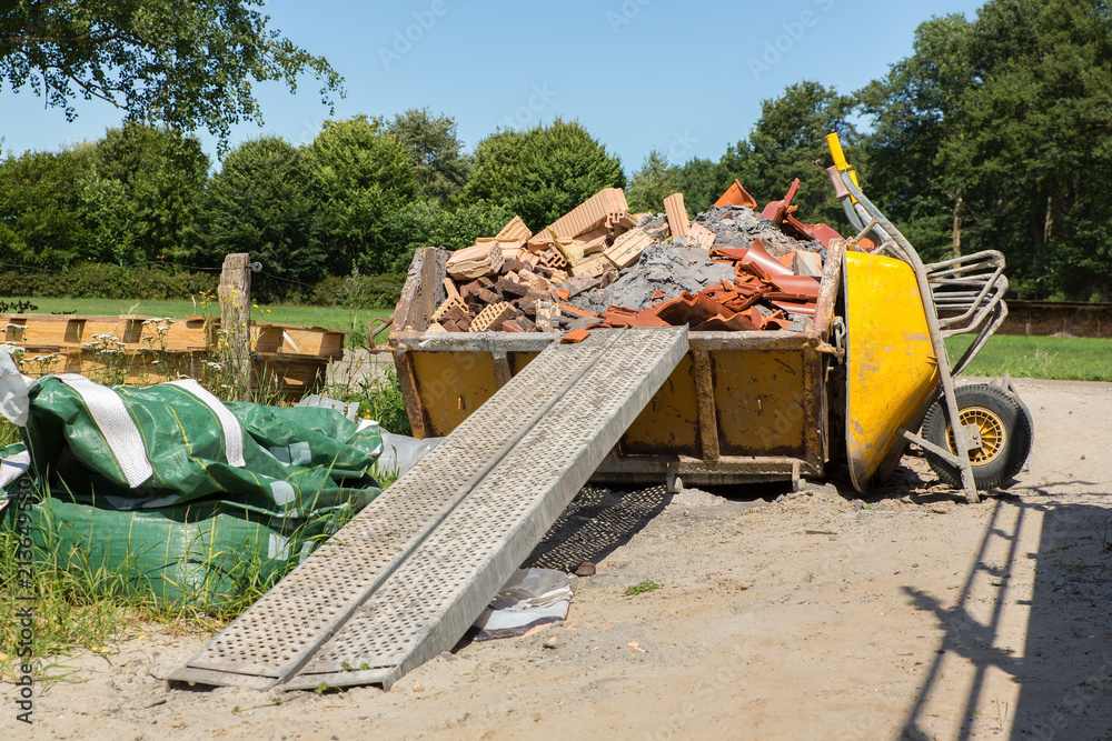 Container with debris and wheelbarrow Stock Photo | Adobe Stock