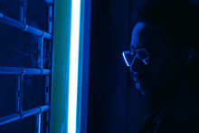 Portrait Of Man With Glasses Reflected In Fluorescent Light