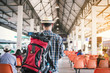 © srijaroen - backpack young man traveler wait at the bus station. Travel concept.