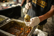 © Alexias - Pouring Beef Soup into Cups at Soup Kitchen