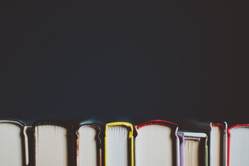 open new colorful books standing on the wooden table. closeup of pages. abstract concept of knowledg