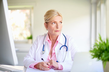 Wall Mural - Overworked senior female doctor