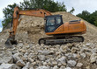 earth mover on heap of rocks in the marble quarry