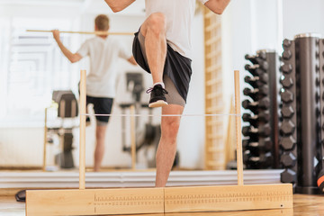 Man exercise with pole in gym 