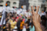 Fototapeta  - A raised hand of a protestor at a political demonstration