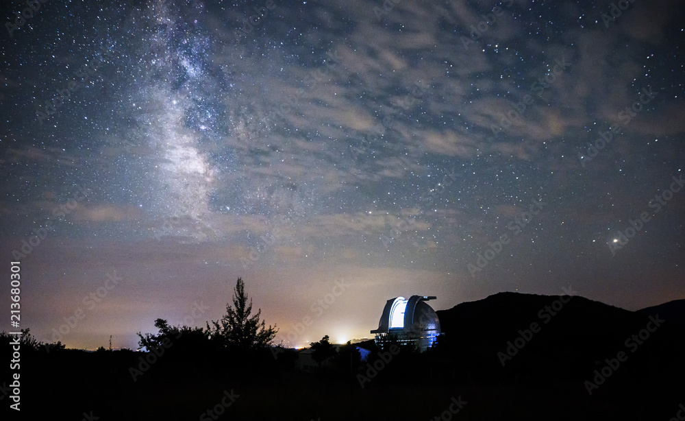 Open dome of a big telescope in an observatory in the background of the starry sky - obrazy, fototapety, plakaty 