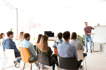 Wall Mural - Male business trainer giving lecture in office