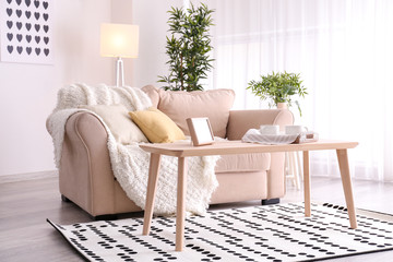 Poster - Elegant living room interior with comfortable sofa and table