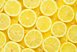 A slices of fresh juicy yellow lemons.  Texture background, pattern.