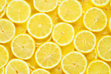 Wall Mural - A slices of fresh juicy yellow lemons.  Texture background, pattern.