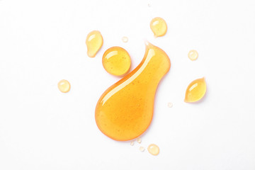 drops of sweet honey on white background, top view