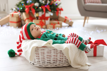 Wall Mural - Cute baby in Christmas costume at home