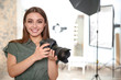 © New Africa - Professional photographer with camera in photo studio