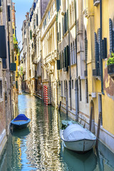 Wall Mural - Motorboats Poles Colorful Small Side Canal Venice Italy