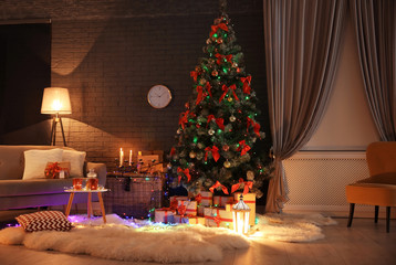 Stylish room interior with decorated Christmas tree