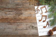 Composition With Music Sheet And Notes On Wooden Background. Christmas Songs Concept
