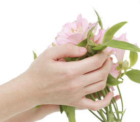 bouquet of flowers in female hands isolated on a light backgrou