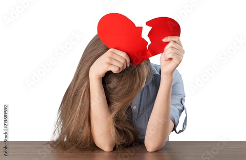 Fotografía Woman ripping up a paper heart isolated