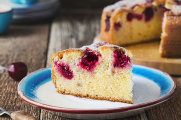 Wall Mural - Slice of cherry cake and fresh summer berries on rustic table