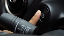 Close Up Of Male Finger Pressing An Engine Start Stop Button On Modern Automatic Car
