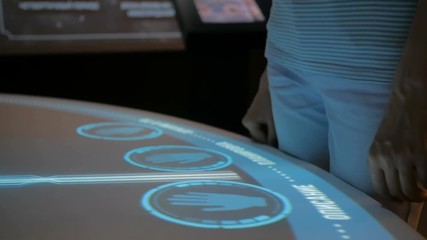 Woman using interactive touchscreen display with no touch control technology at modern history museum. Education and modern concept
