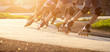 Group of teenagers skating on track in summer evening. Abstract panoramic short track speed skating sport background