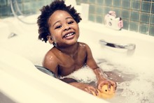 African Descent Kid Enjoying Bath Tub