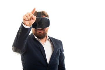 Wall Mural - Business man wearing vr goggles pointing invisible touchscreen.