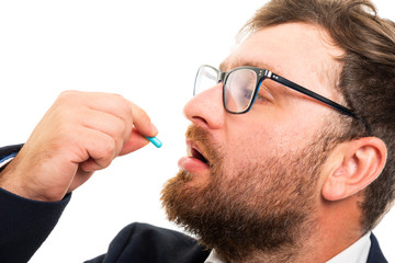 Wall Mural - Close up of business man taking pill.