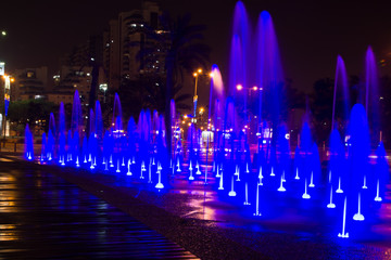 Fountain colored water show. Colorful fontain light in city