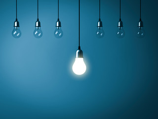 Poster - Stand out from the crowd and leadership creative idea concepts One hanging light bulb glowing with unlit incandescent bulbs on dark blue background 3D rendering