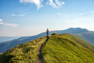 Wall Mural - young woman hiking in the mountains