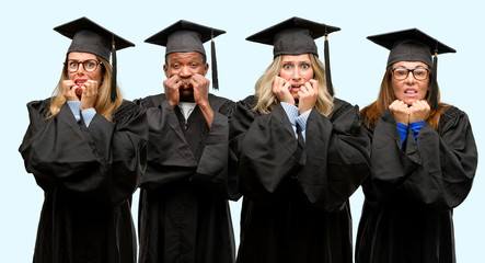 Sticker - Education concept, university graduate woman and man group terrified and nervous expressing anxiety and panic gesture, overwhelmed