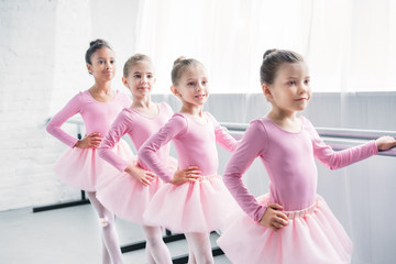 Wall Mural - adorable little ballerinas practicing ballet in studio