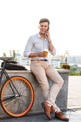 Poster - Smiling young stylish man talking on mobile phone