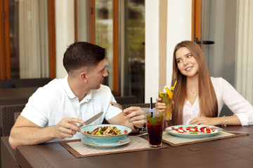 Wall Mural - Happy loving couple enjoying breakfast in a cafe.