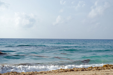 Caribbean Sea beach with sky horizon and water. Wave, cloud