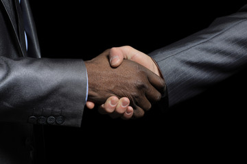 Handshake of Afro American and caucasian male hands