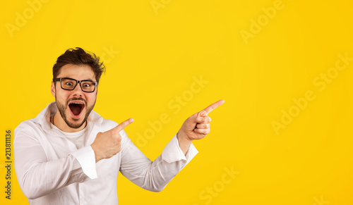 Hipster man pointing away with excitement Tableau sur Toile