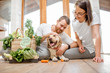 © rh2010 - Young lovely couple sitting together with their dog and fresh green vegetables at home