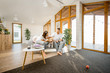 © rh2010 - Wide view on the cozy living room interior of the house with young couple and their dog indoors