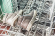 © Evgenii - Childrens shoes lie in the dishwasher machine for washing