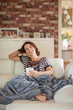 © Kanea - Beautiful best age woman lying on the couch relaxing, enjoying life, drinking coffee, carefree, happy mood