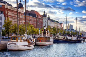 beautiful cityscape, helsinki, the capital of finland, view of the embankment with boats and houses,