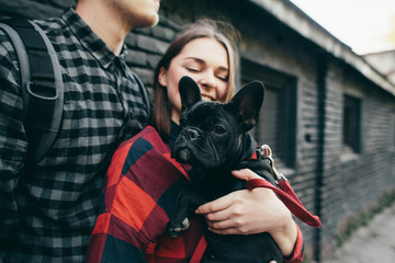 Loving couple with pet french bulldog