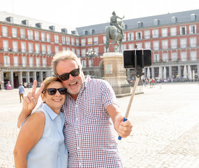 Happy retired senior tourist Couple Standing Taking Selfie in a European city